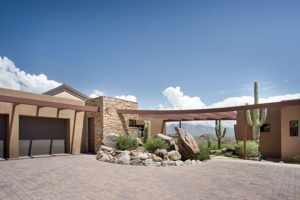 Large and brown contemporary bungalow render house exterior in Phoenix with a flat roof.