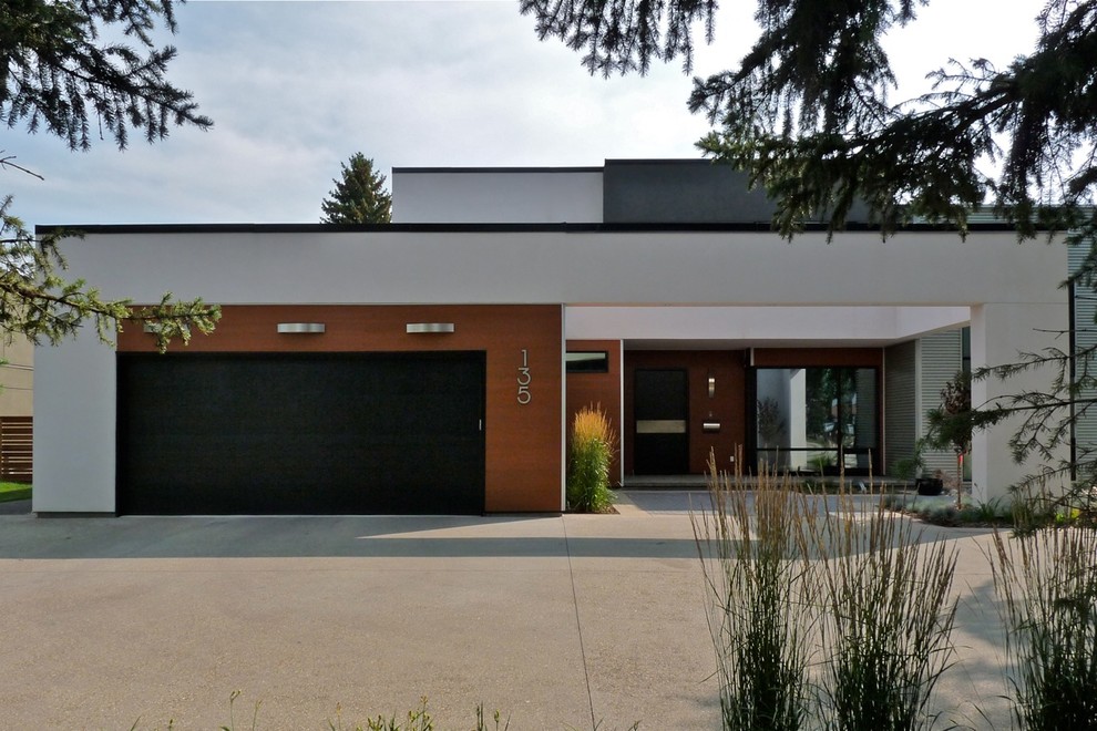 Large minimalist white two-story stucco exterior home photo in Edmonton