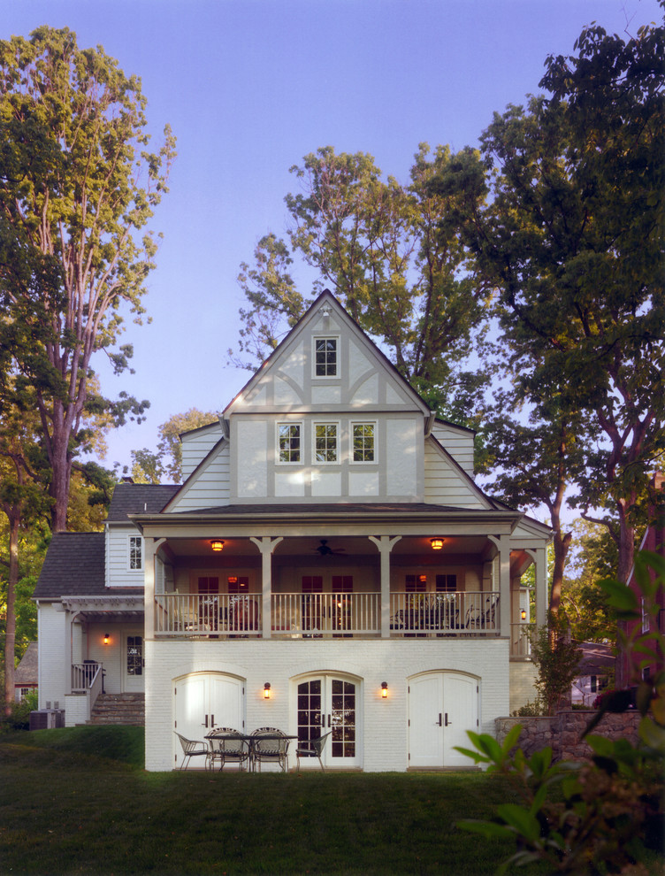 Aménagement d'une façade de maison blanche classique en bois de taille moyenne et à un étage avec un toit à deux pans et un toit en shingle.
