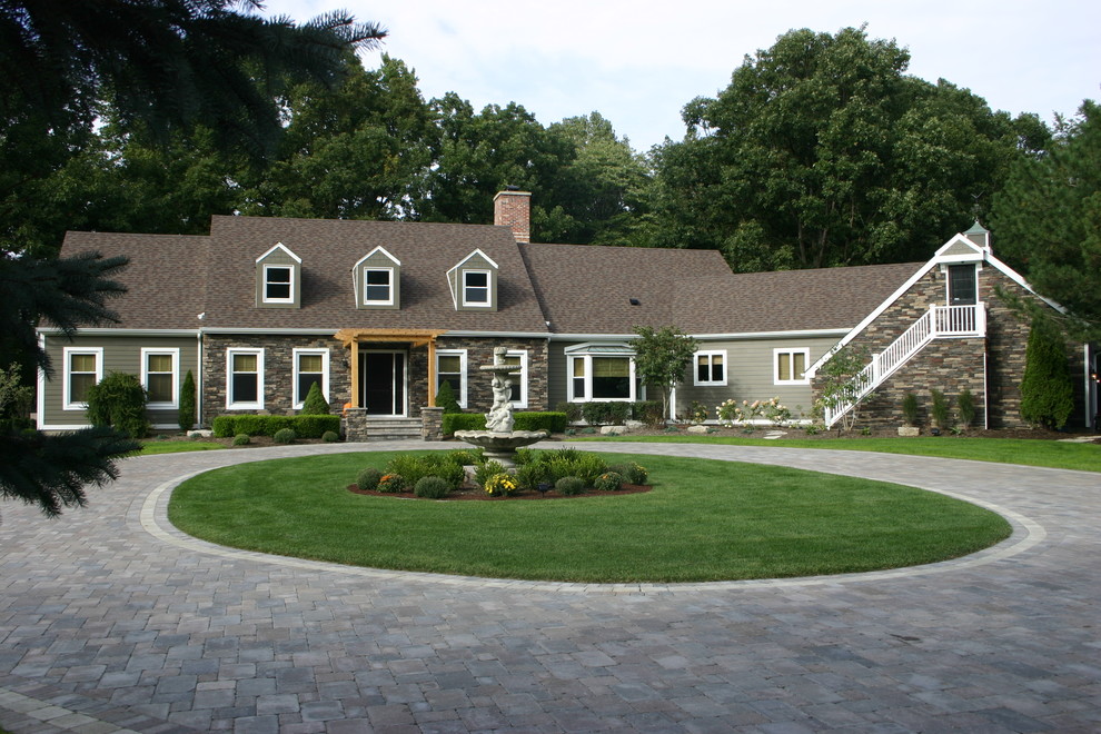 На фото: большой, двухэтажный, разноцветный дом в классическом стиле с облицовкой из ЦСП и двускатной крышей