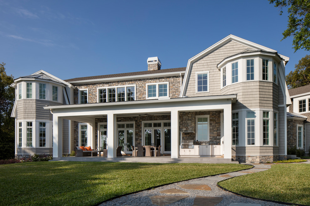 Large coastal gray two-story mixed siding house exterior idea in Jacksonville with a shingle roof