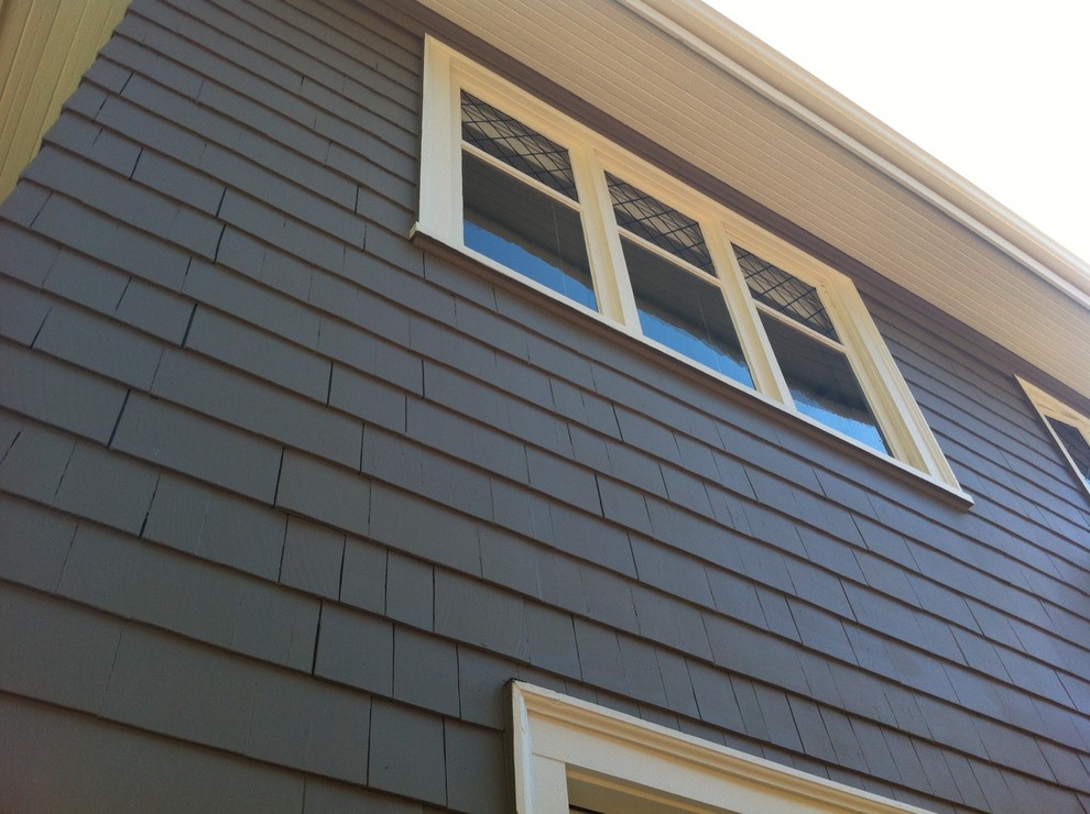 This is an example of a large classic two floor house exterior in Seattle with wood cladding.
