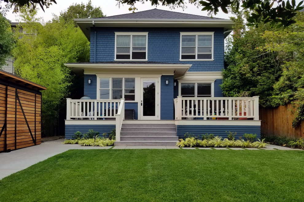This is an example of a medium sized and blue traditional two floor detached house in Seattle with mixed cladding, a hip roof and a shingle roof.