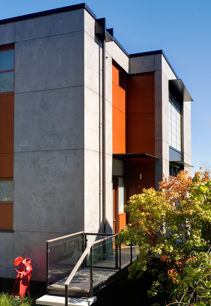 Ispirazione per la facciata di una casa contemporanea con rivestimento in cemento