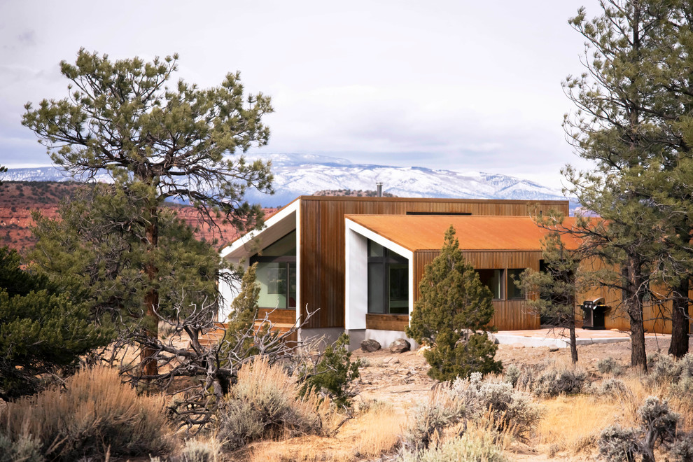 Inspiration for a small contemporary bungalow house exterior in Salt Lake City with metal cladding and a lean-to roof.