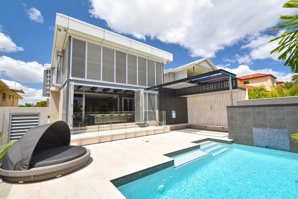 Example of a huge minimalist white three-story metal exterior home design in Brisbane with a metal roof