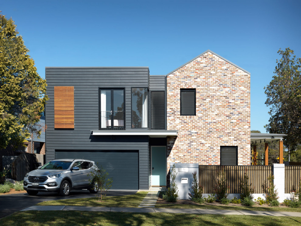 Design ideas for a large and multi-coloured contemporary two floor brick semi-detached house in Sydney with a pitched roof and a metal roof.