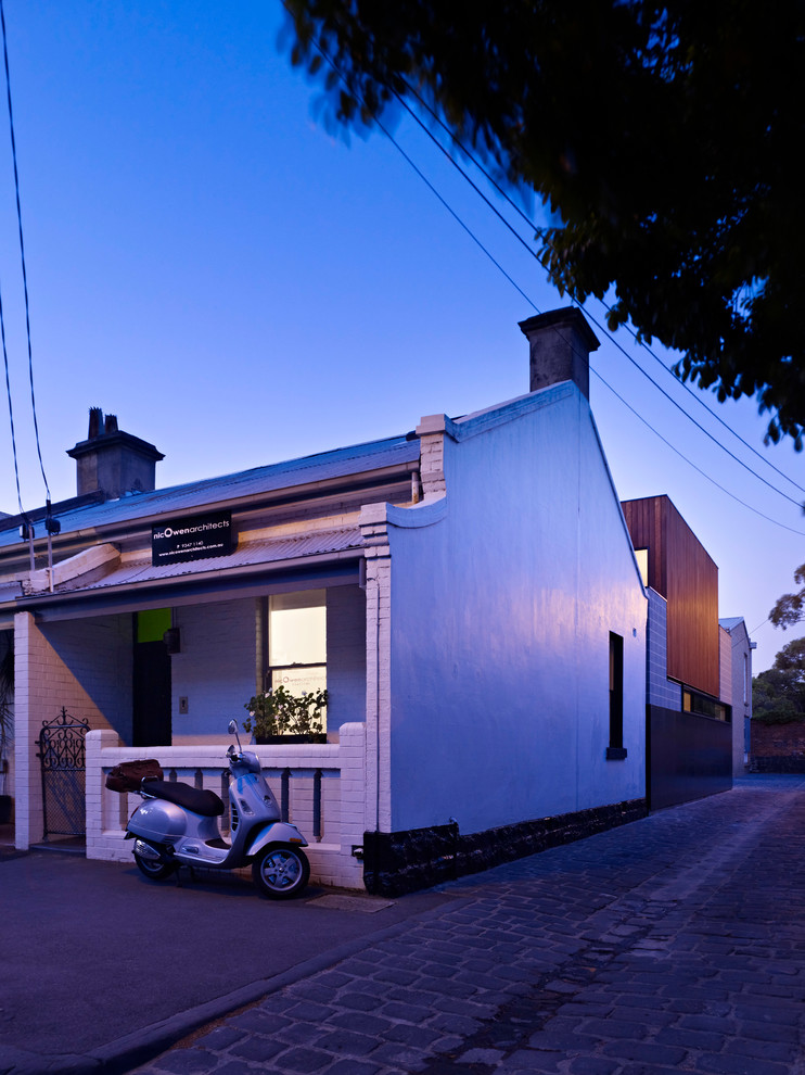 Design ideas for a small and black modern two floor house exterior in Melbourne with wood cladding and a pitched roof.