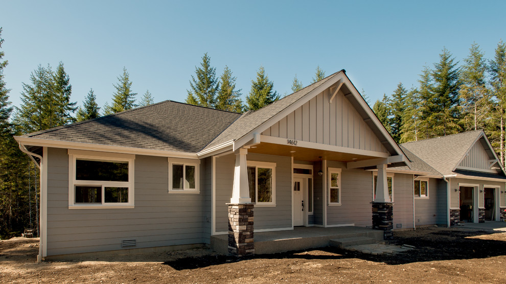 This is an example of a medium sized and gey classic bungalow detached house in Seattle with vinyl cladding, a pitched roof and a shingle roof.