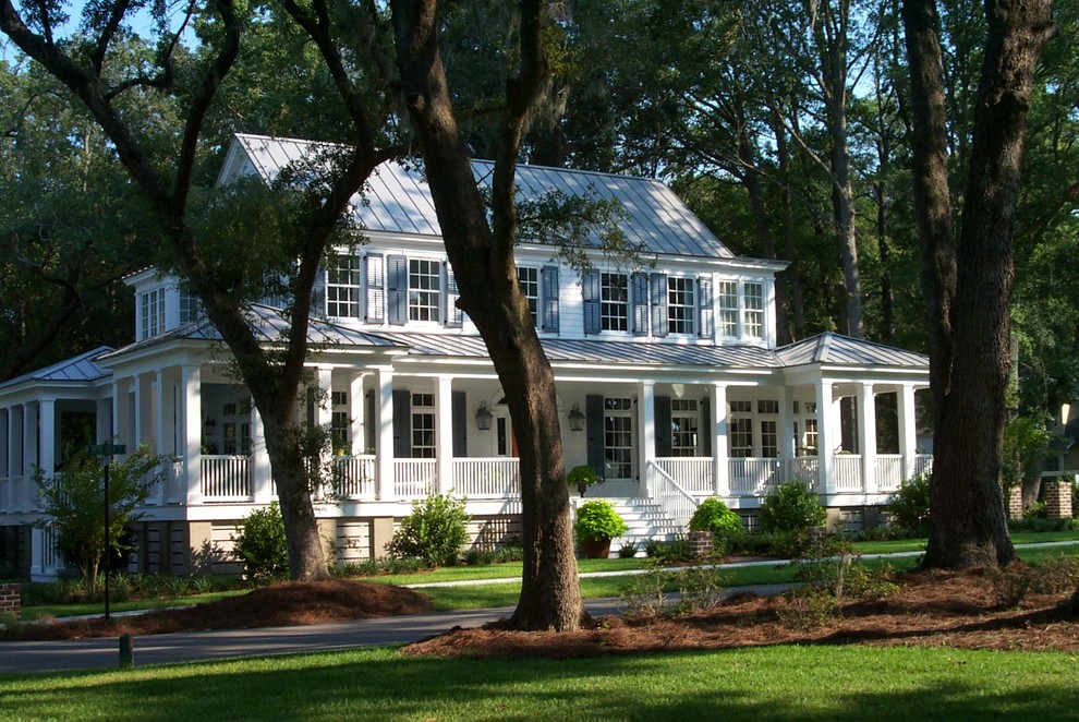 Пример оригинального дизайна: двухэтажный, белый дом в классическом стиле с двускатной крышей