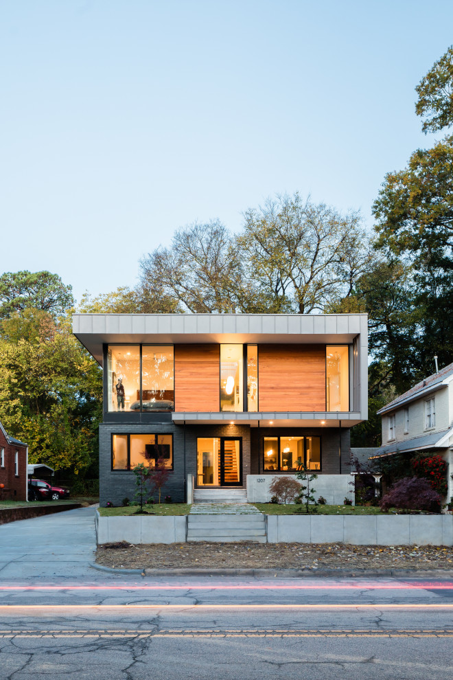 Diseño de fachada de casa minimalista de dos plantas con revestimientos combinados y tejado plano