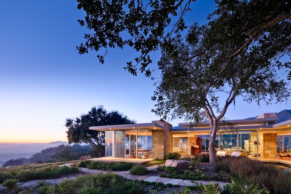 Inspiration for a modern house exterior in Santa Barbara with stone cladding.