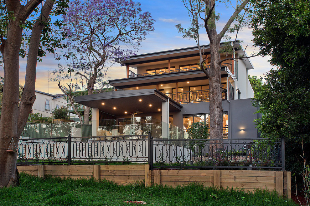 Example of a large trendy gray three-story house exterior design in Sydney