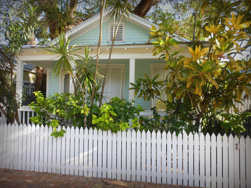 Idee per la facciata di una casa piccola verde tropicale a un piano con rivestimento in legno