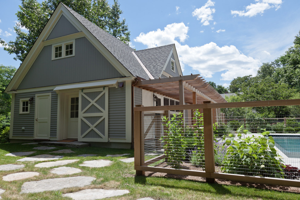 Photo of a gey rural house exterior in Boston with wood cladding.