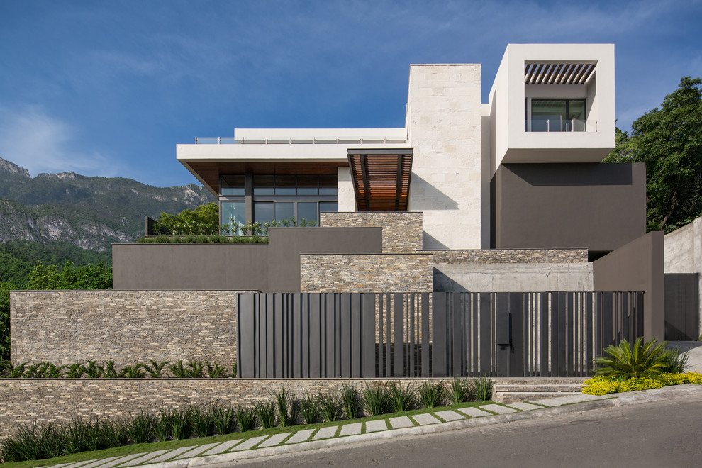 Foto de fachada de casa multicolor contemporánea con revestimientos combinados y tejado plano