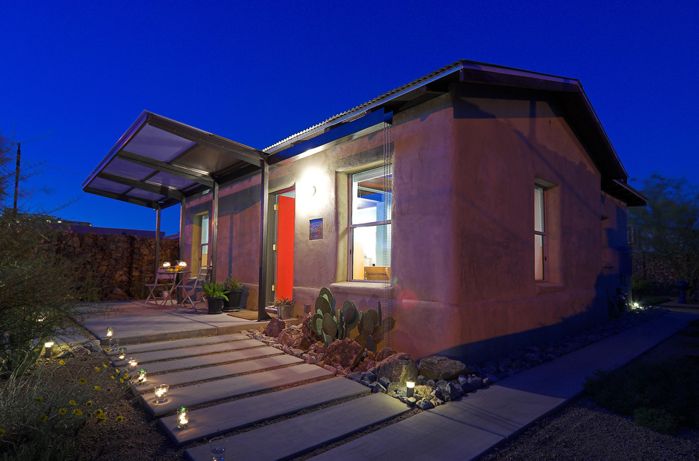 Photo of a small eclectic bungalow render house exterior in Phoenix.
