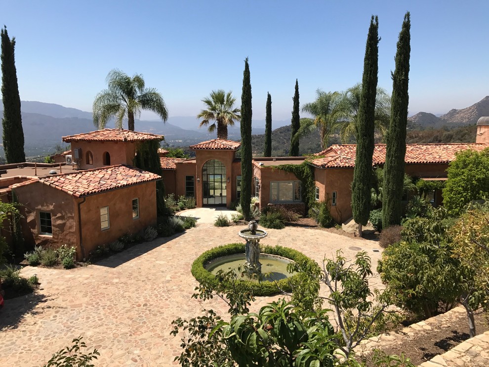 Tuscan brown one-story exterior home photo in Los Angeles with a tile roof
