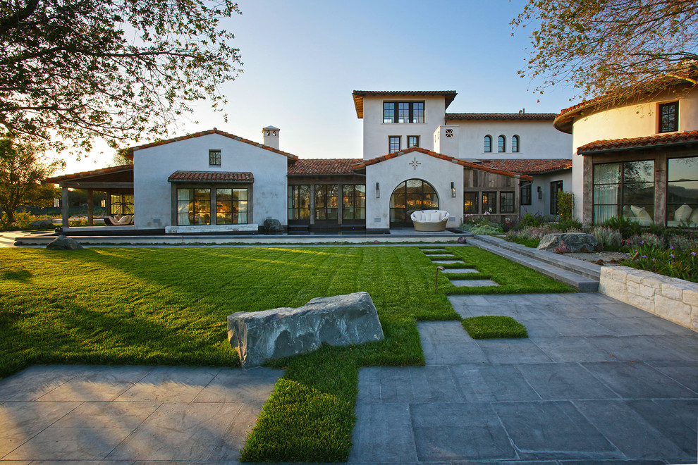 Inspiration for a large mediterranean house exterior in Orange County with a tiled roof.