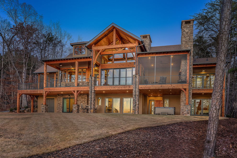 Inspiration for a mid-sized rustic beige one-story house exterior remodel with a shingle roof