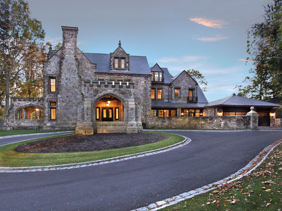 На фото: большой, трехэтажный, разноцветный дом в классическом стиле с облицовкой из камня и коричневой крышей