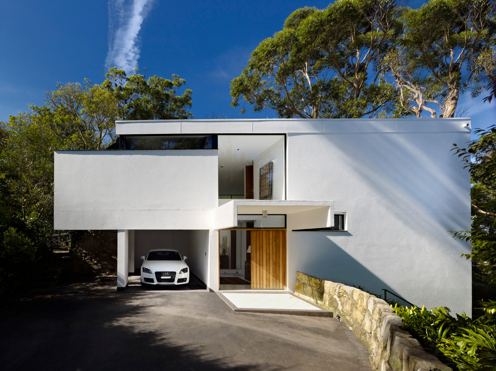 Medium sized and white modern house exterior in Sydney.