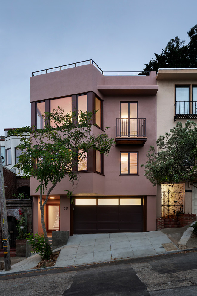 Idée de décoration pour une façade de maison rose minimaliste.