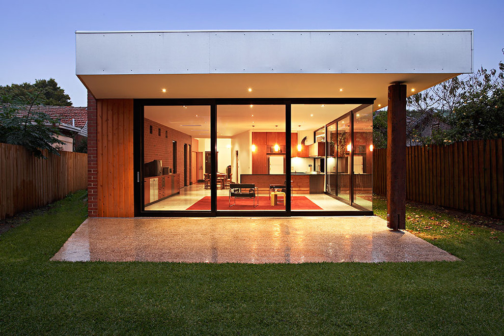 Example of a minimalist one-story glass exterior home design in Melbourne