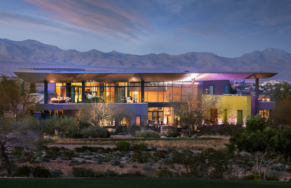 Design ideas for a contemporary two floor glass house exterior in Las Vegas.