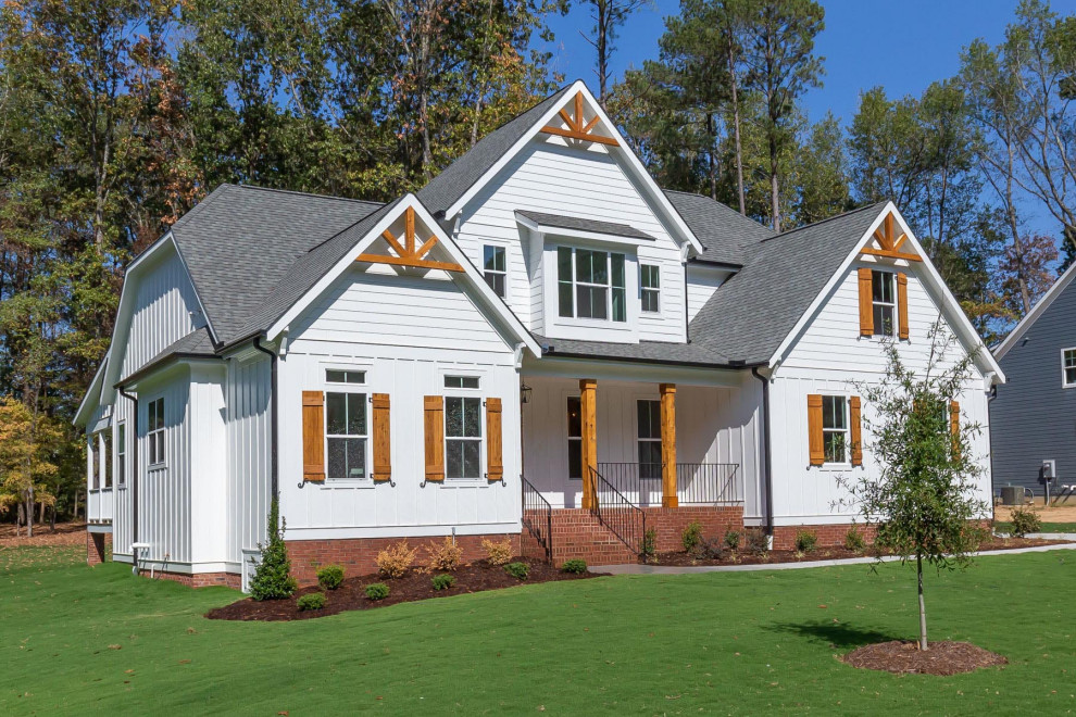 Mid-sized traditional white two-story wood exterior home idea in Raleigh with a shingle roof