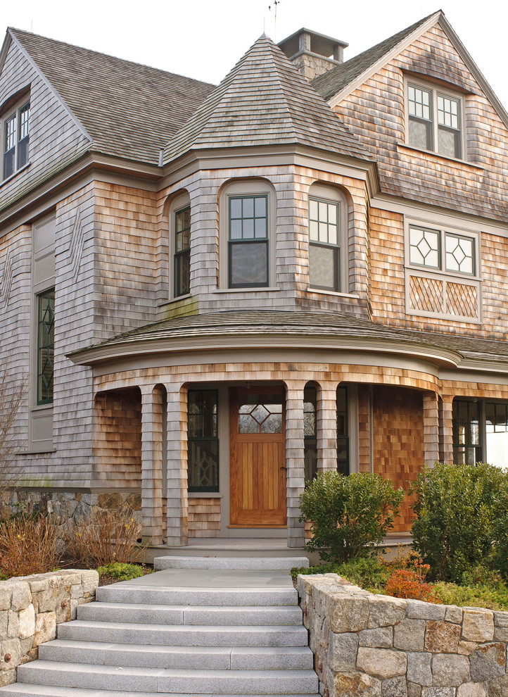 This is an example of a large victorian house exterior in Boston with three floors and wood cladding.