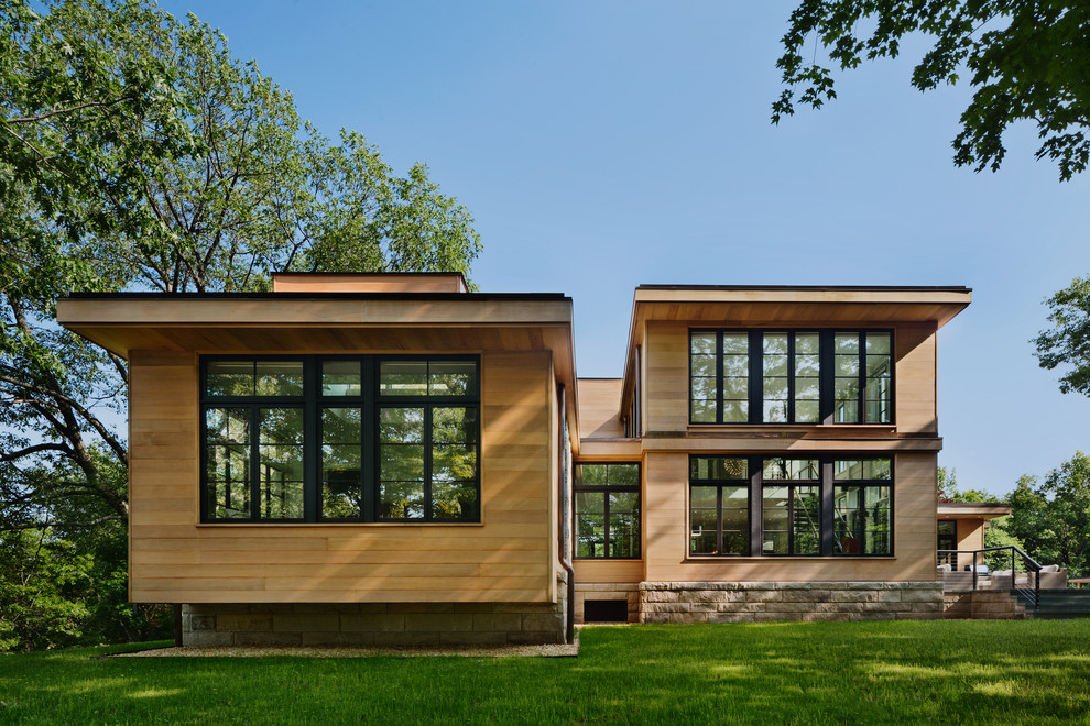 Inspiration for a contemporary house exterior in New York with wood cladding.