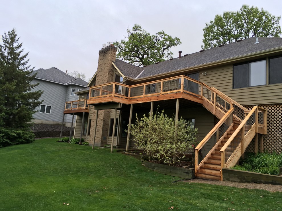 Example of a large arts and crafts beige two-story vinyl exterior home design in Minneapolis with a hip roof