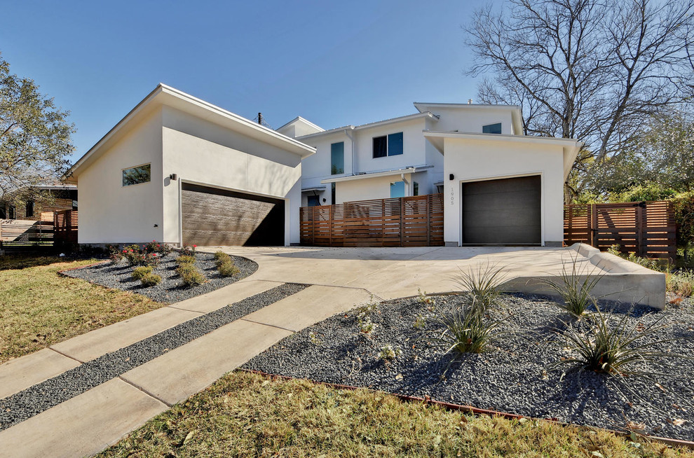 Beige modern two floor house exterior in Austin with mixed cladding and a flat roof.