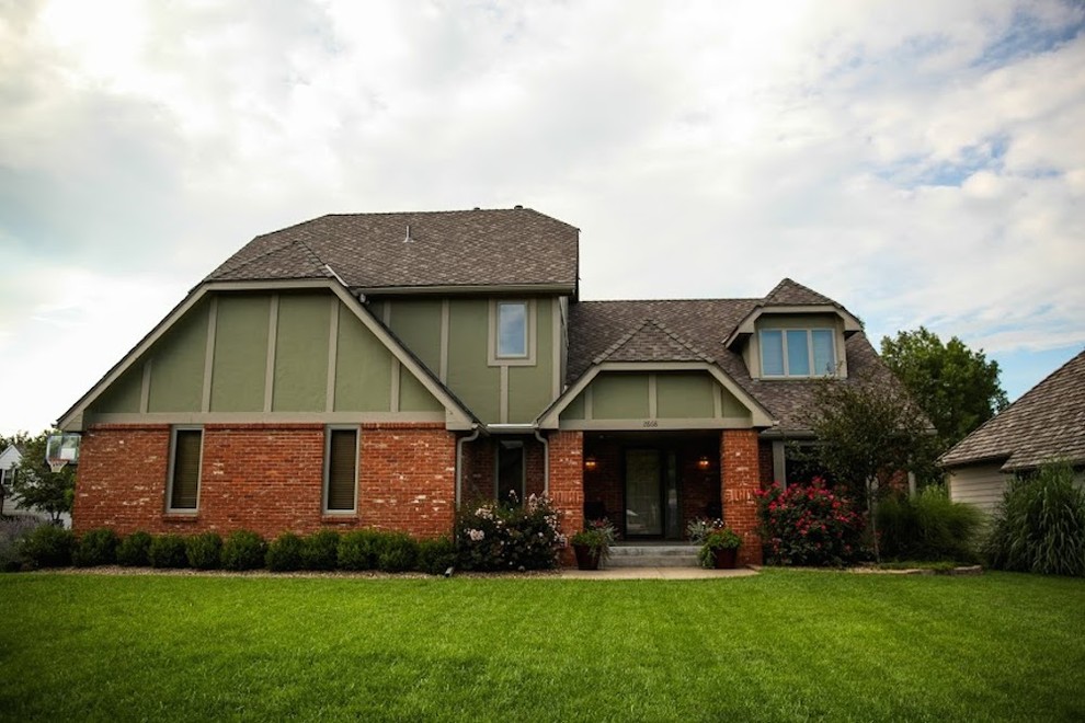 Inspiration for a large and red classic two floor brick house exterior in Wichita with a half-hip roof.