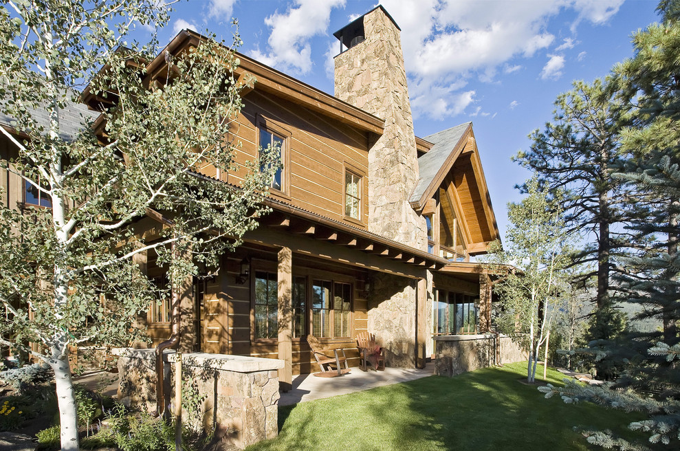 Example of a mountain style brown two-story wood house exterior design in Other