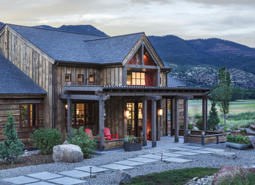 Mountain style brown wood exterior home photo in Other with a shingle roof