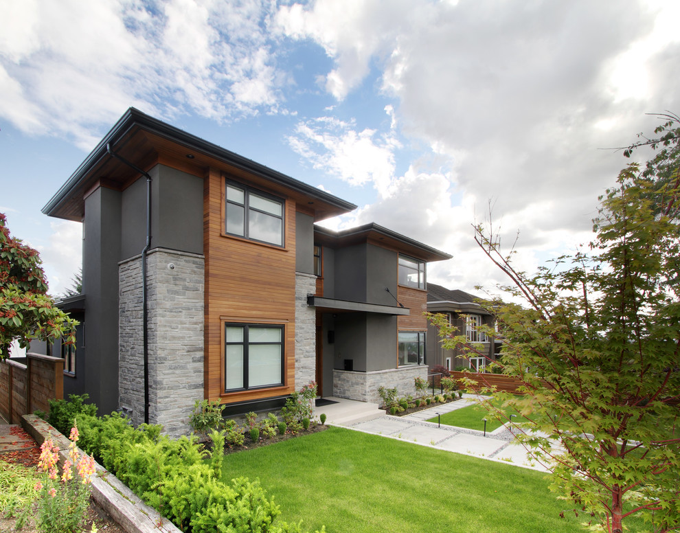 Mittelgroßes, Zweistöckiges Modernes Einfamilienhaus mit Backsteinfassade, grauer Fassadenfarbe und Flachdach in Vancouver