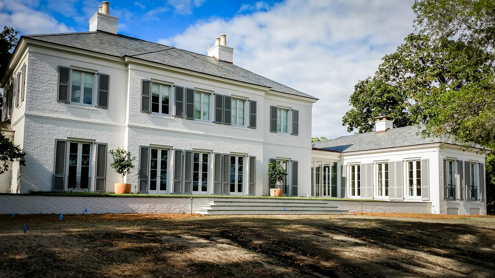 Zweistöckiges Klassisches Einfamilienhaus mit Backsteinfassade, weißer Fassadenfarbe und Walmdach in Charleston