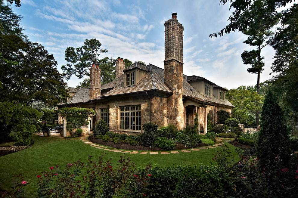 Traditional stone exterior home idea in Charlotte with a hip roof