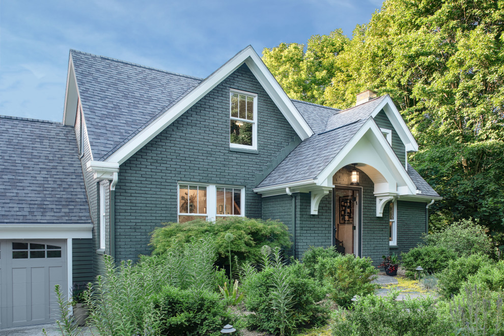 Imagen de fachada de casa verde de estilo americano de tamaño medio de dos plantas con revestimiento de ladrillo, tejado a dos aguas y tejado de teja de madera