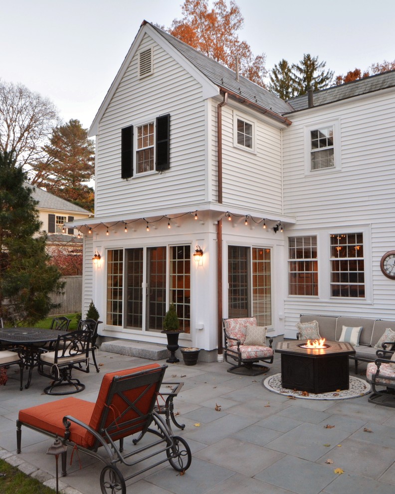 Example of a classic white two-story vinyl exterior home design in Boston