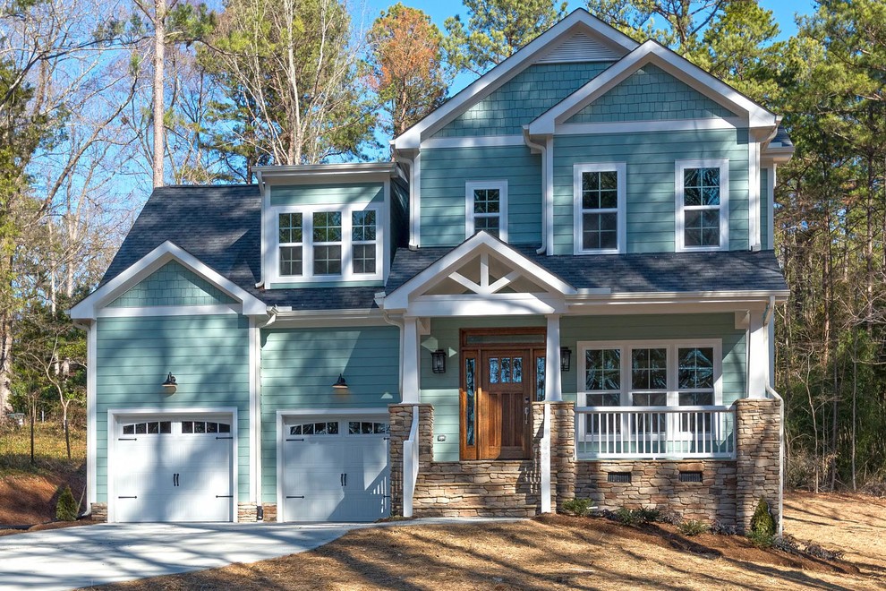Ejemplo de fachada de casa azul de estilo americano de tamaño medio de dos plantas con revestimiento de aglomerado de cemento, tejado a dos aguas y tejado de teja de madera