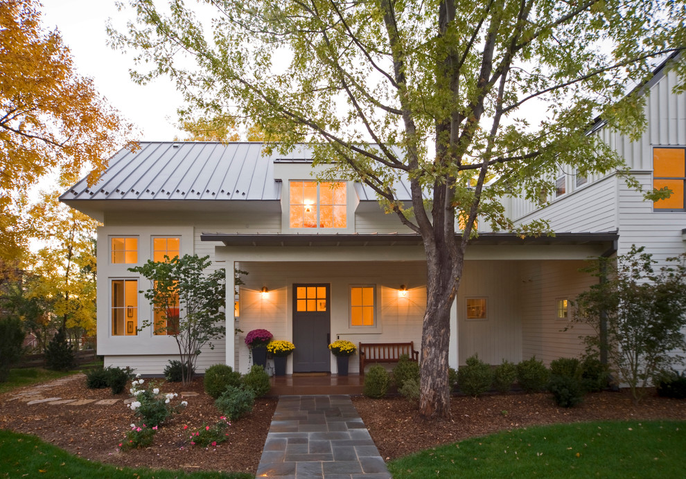 Example of a mid-sized farmhouse white two-story wood exterior home design in Denver with a metal roof and a white roof