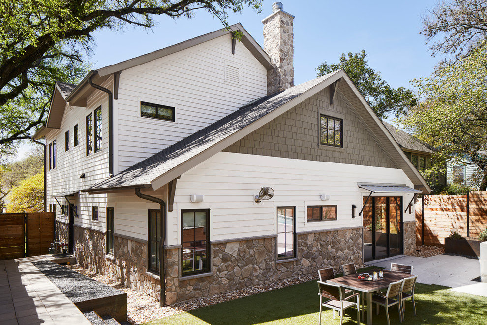 Classic two floor house exterior in Austin with mixed cladding, a pitched roof and a shingle roof.