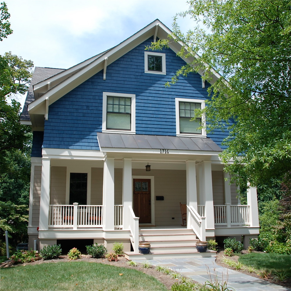 Photo of a medium sized and blue classic house exterior in DC Metro with three floors, wood cladding and a pitched roof.