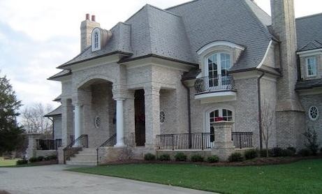 Traditional white two-story brick exterior home idea in Other
