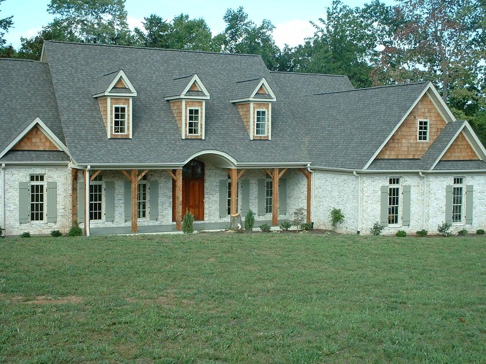 Traditional white two-story brick exterior home idea in Other