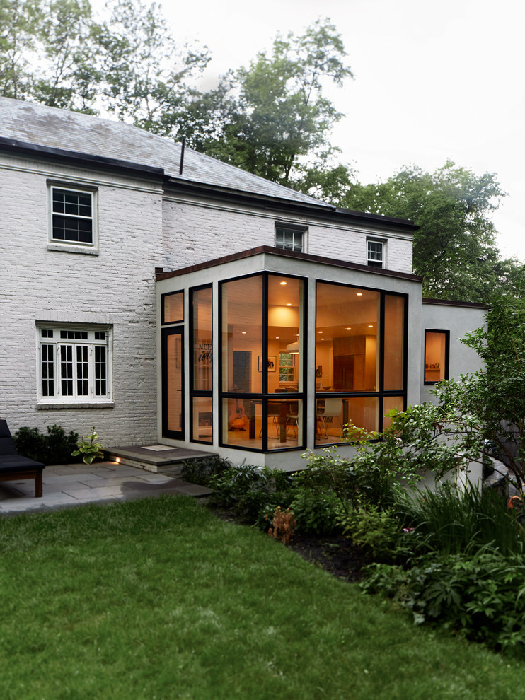 Aménagement d'une petite façade de maison blanche contemporaine en stuc de plain-pied avec un toit plat et un toit mixte.