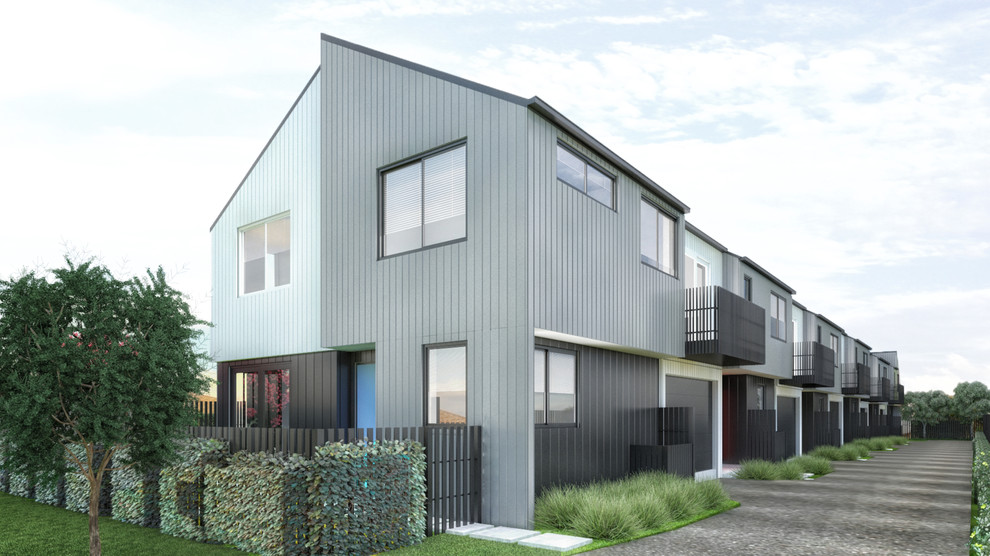 This is an example of a gey contemporary two floor terraced house in Auckland with wood cladding, a pitched roof and a mixed material roof.